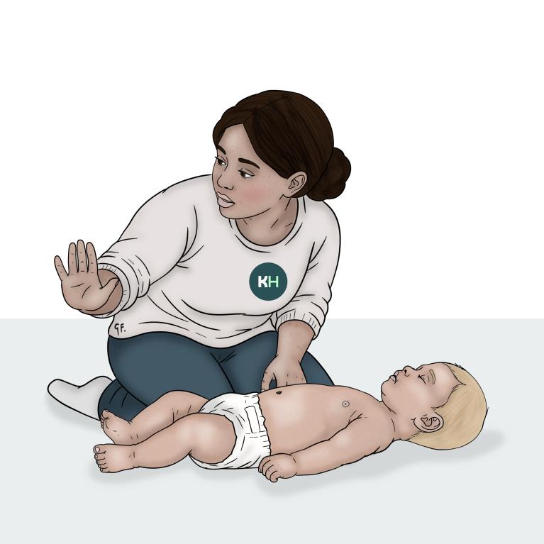 A woman kneels beside a baby lying on their back and holds out one hand as she checks the area around them.