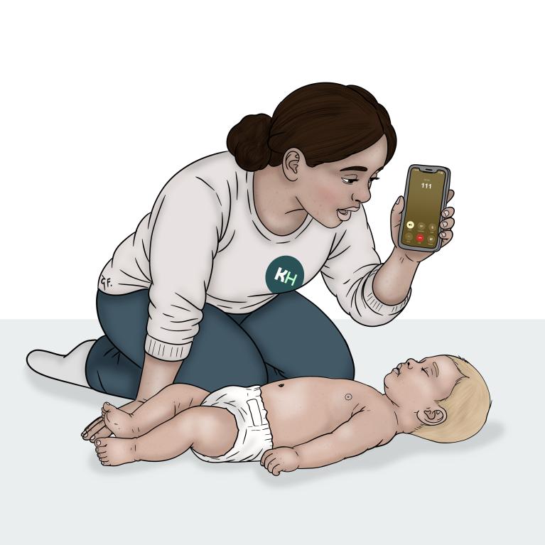 A woman kneels beside a baby lying on their back and speaks into a phone showing a call to 111.