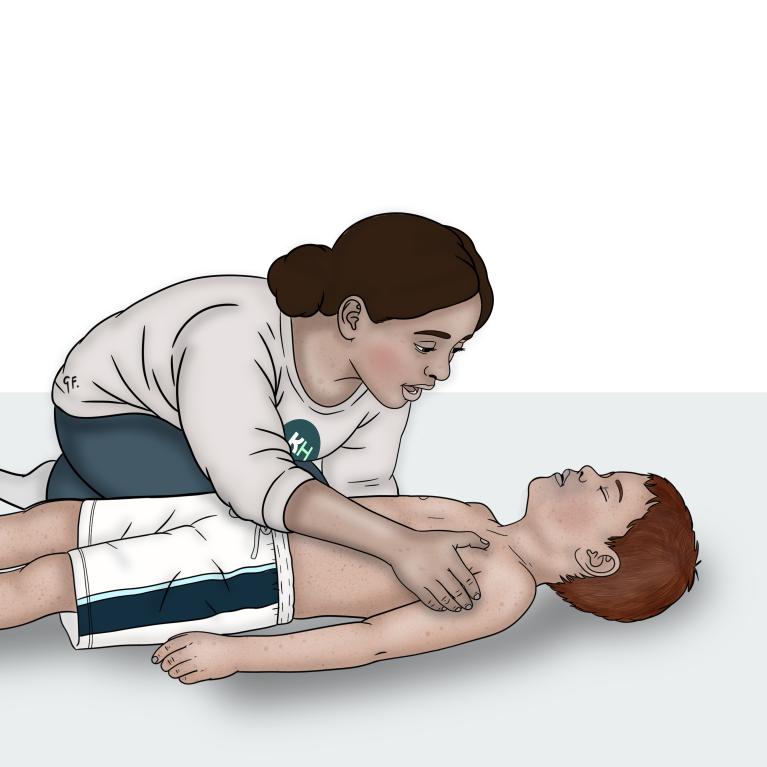 A woman leans over a child lying on their back and places her hand on the child’s shoulder gently squeezing it to check for a response.