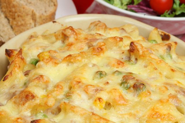Baked tuna pasta topped with melted golden cheese in a baking dish.