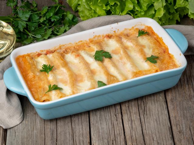 Baked savoury pancakes covered with melted cheese in a rectangular casserole dish.