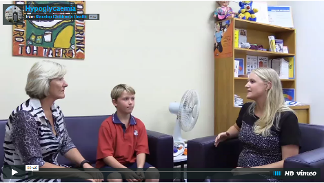 Thumbnail image of a video still showing two women and a boy seated and talking.