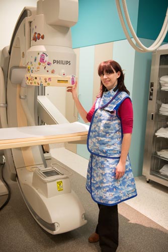 image of radiographer next to a fluoroscopy machine