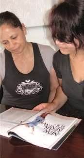 Photo of mother and teenage daughter reading together