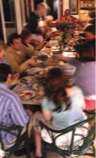 Photo of large group eating around a table