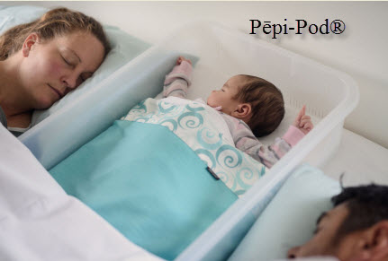Mother and father sleeping with their baby in a Pepi-pod