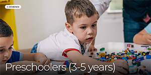 Screenshot of preschoolers' development page of Raising Children Australia website - photo of a preschooler leaning over a table covered with toys