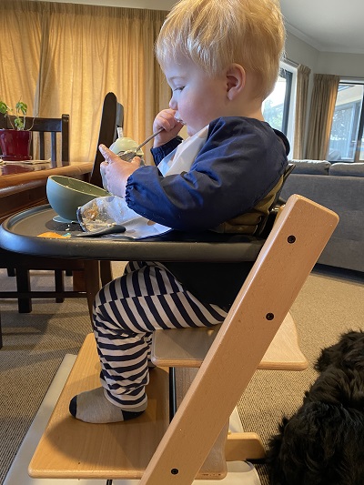 Child in a high chair eating food
