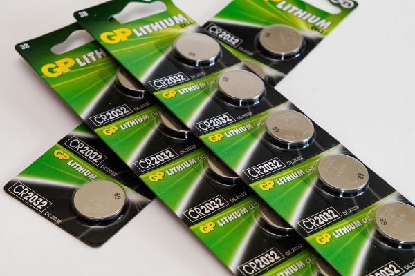 A photo of lithium button batteries in a green packet 