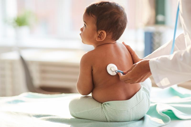 Baby being examined my doctor with a stethoscope 