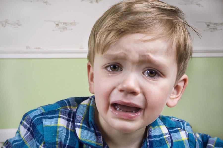 Young boy crying before bedtime
