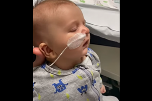 Baby with oxygen tube having trouble breathing