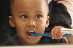 Young child brushing their teeth 