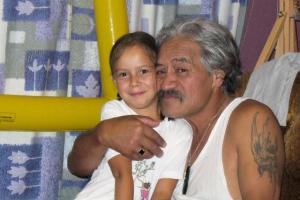 Grandfather hugging his granddaughter in hospital