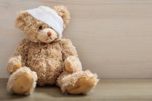 Teddy bear with a bandage on its head
